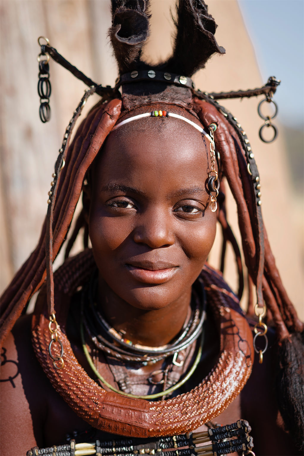 Portrait of a young Himba woman dressed in traditional style in Namibia, Africa.